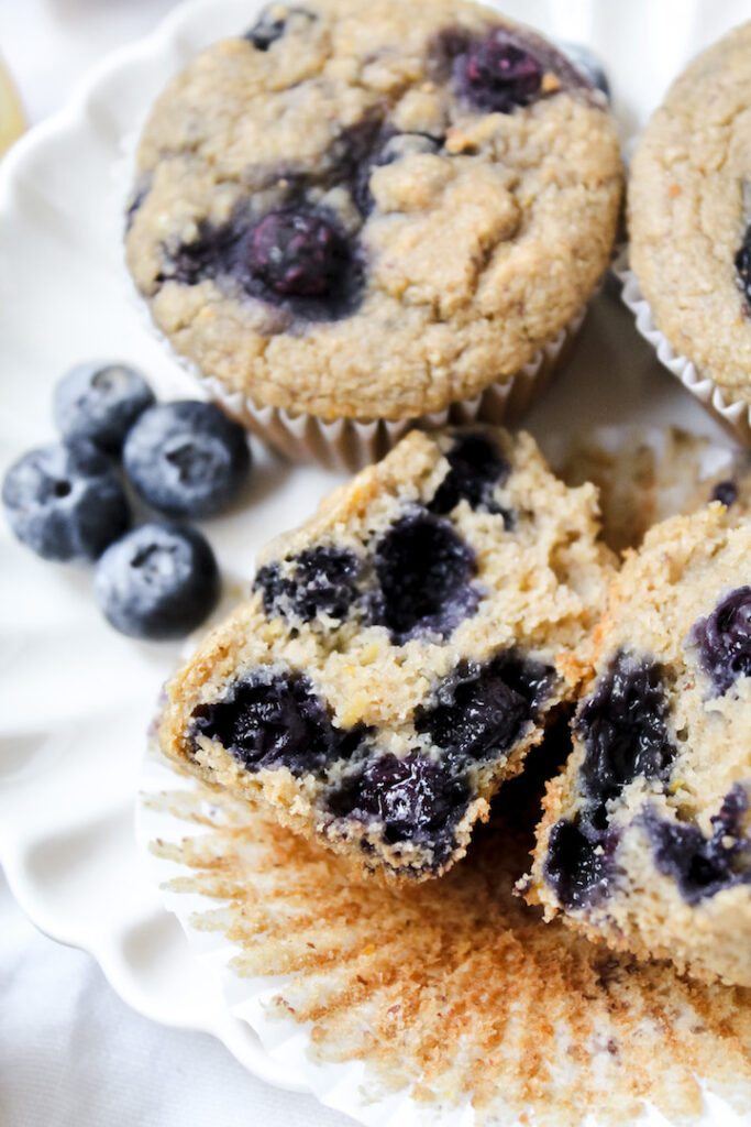 inside shot of muffin with blueberries on the side