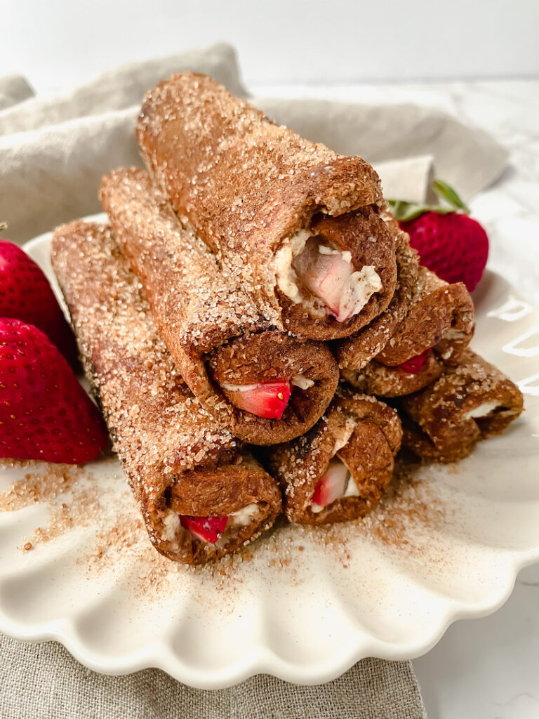 close up angle shot of french toast roll ups stacked in a pyramid shape