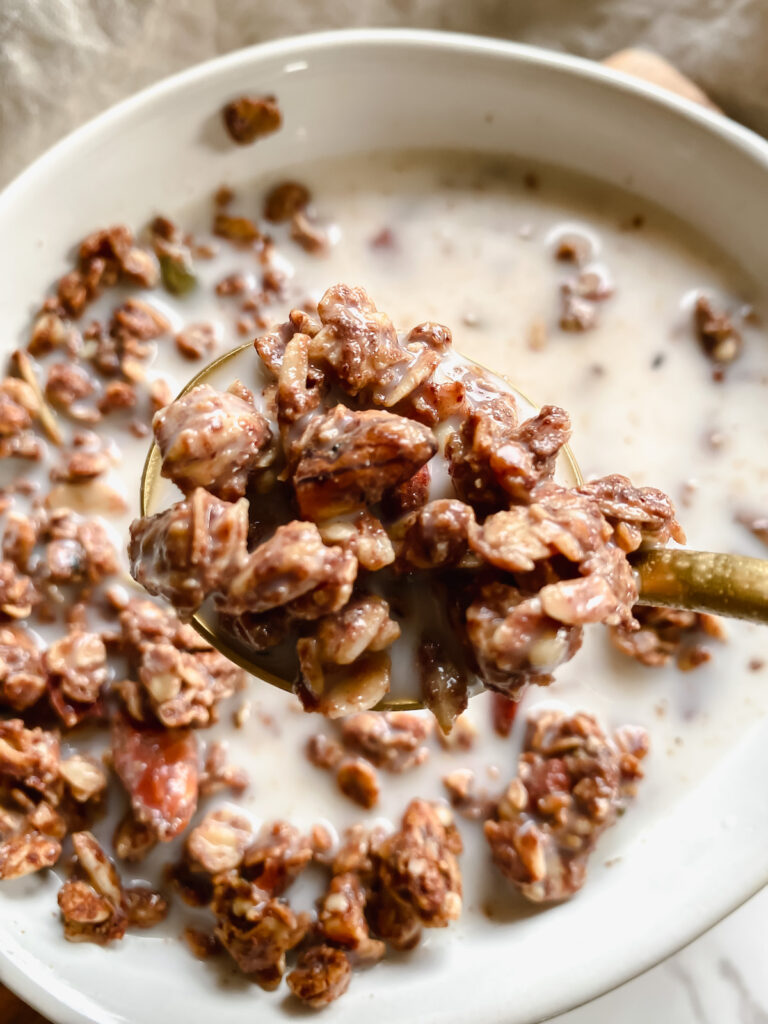 spoonful of peanut butter cacao granola with milk