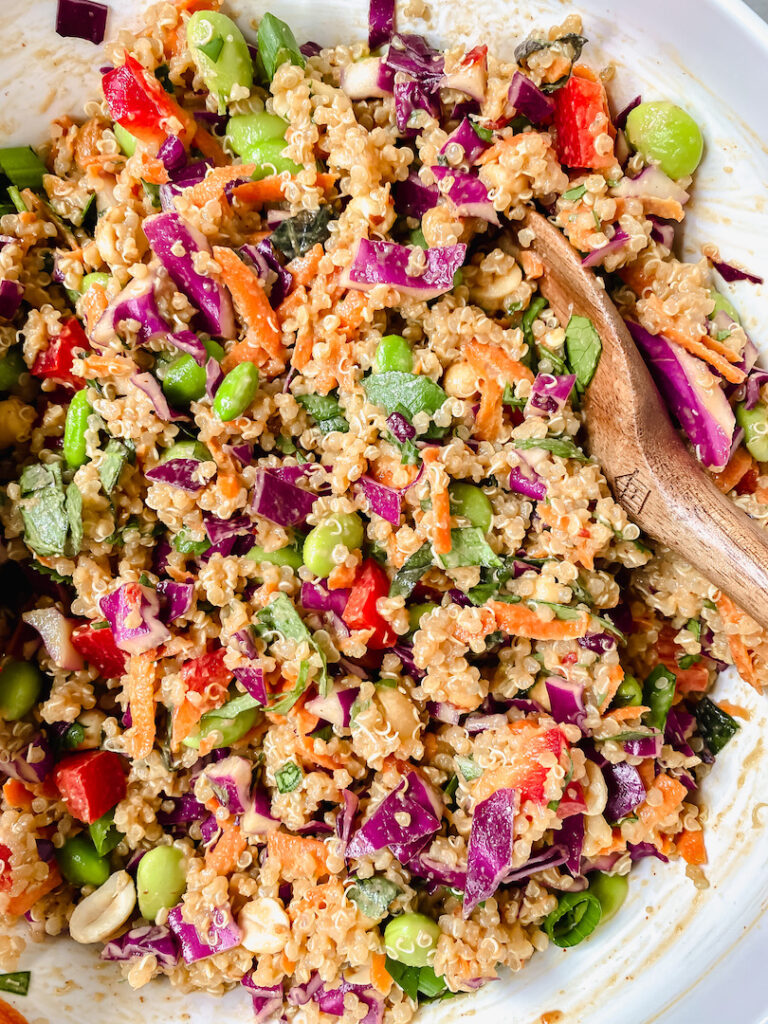 photo of thai quinoa salad with wooden serving spoons 