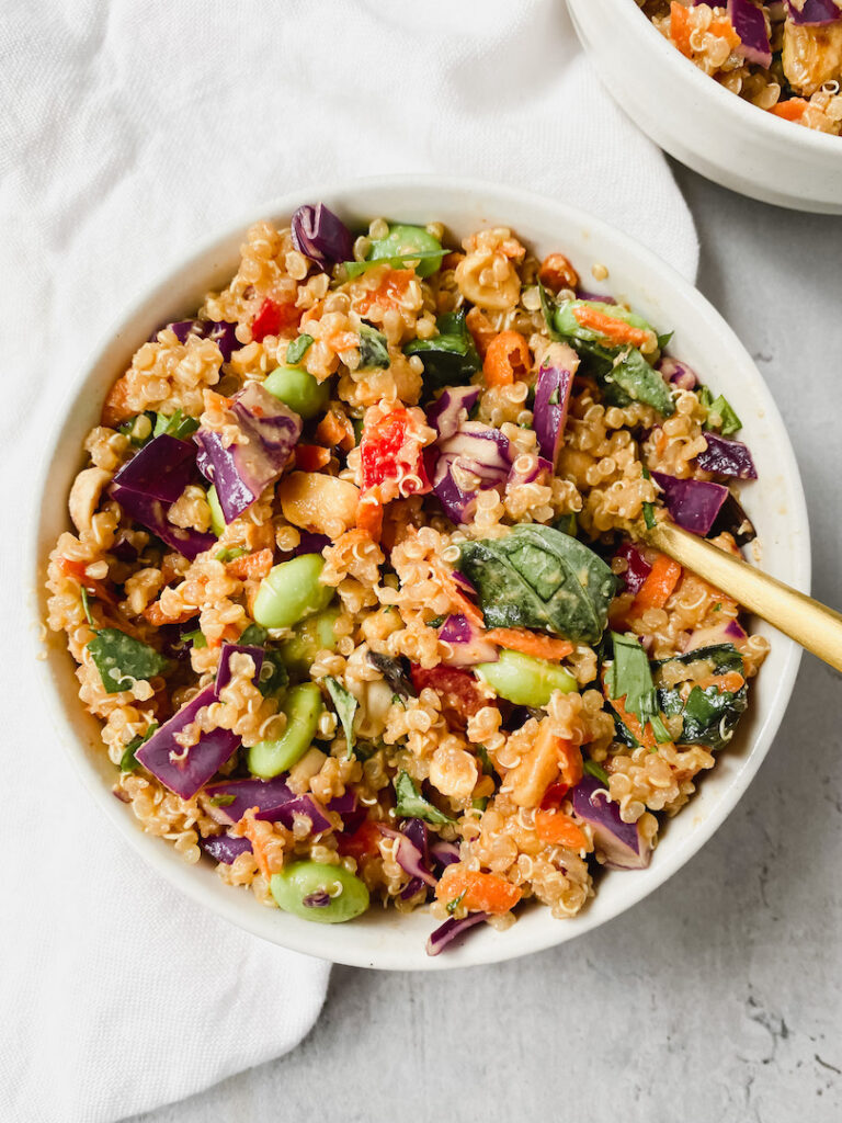 close up of quinoa salad with fork inside