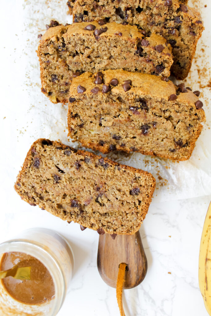 slice of banana bread flat with other slices leaning against each other 