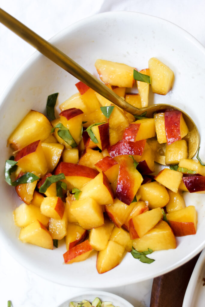 bowl of peaches with basil