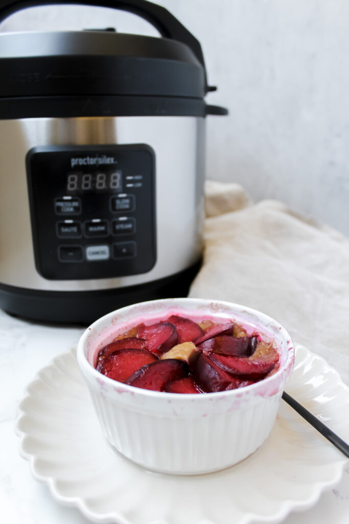 photo of plum baked oats with pressure cooker in the background