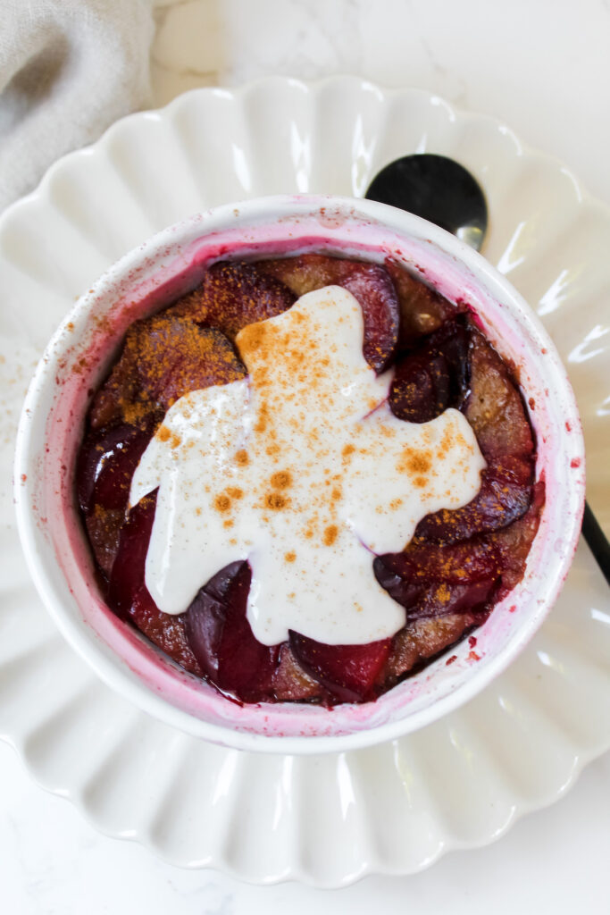 overview shot of pressure cooker plum baked oats with yogurt and cinnamon on top