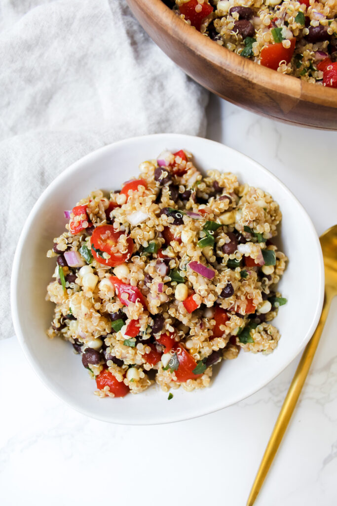 bowl of southwest quinoa salad and a gold spoon on the side