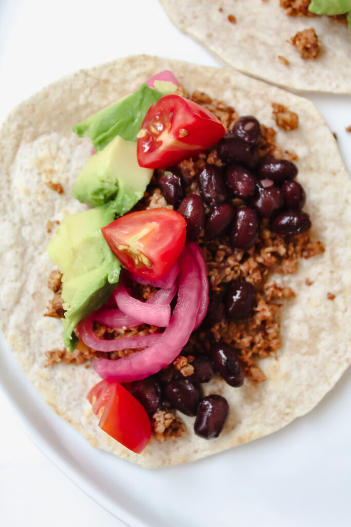 overview shot of a taco with the cauliflower walnut taco meat in it