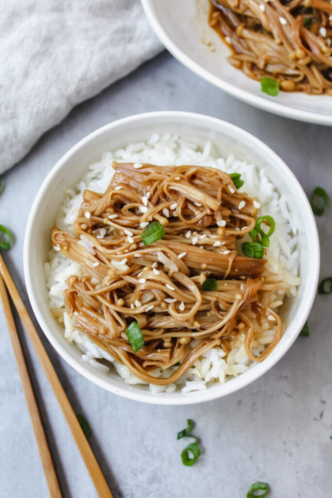 miso soy enoki mushrooms on top of a bowl of rice