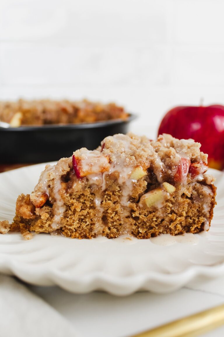 a slice of vegan apple crumb cake on a white plate