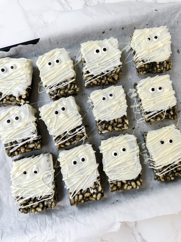 overview shot of entire tray of mummy rice krispie treats
