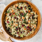 overview shot of roasted sweet potato quinoa stuffing in a wooden bowl