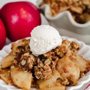 apple crisp with ice cream on a white plate