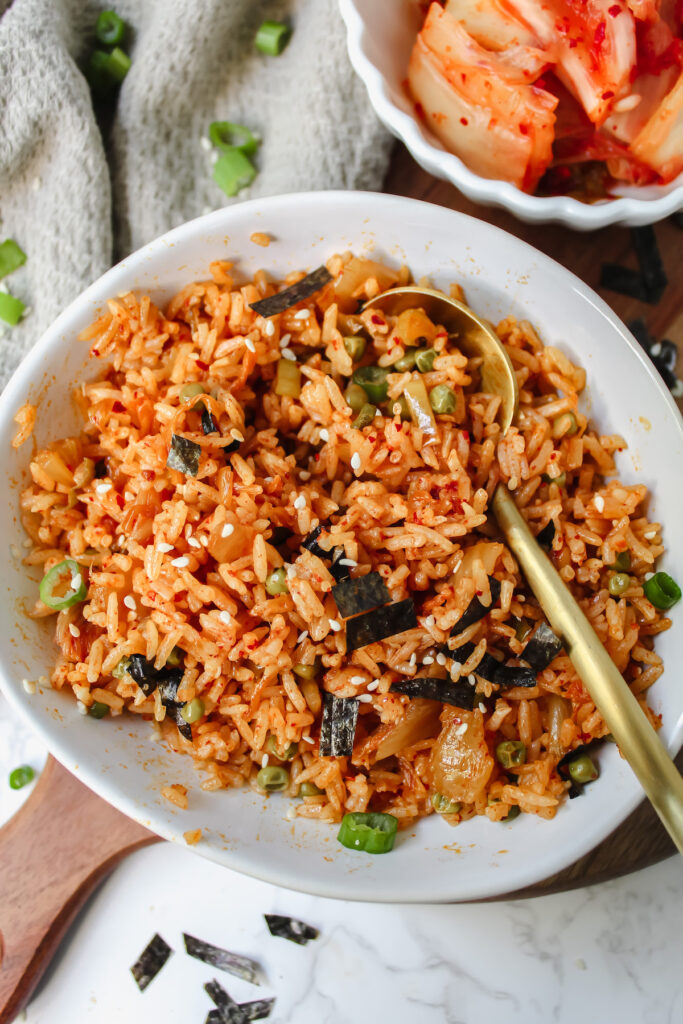 bowl of kimchi fried rice with a gold spoon in it