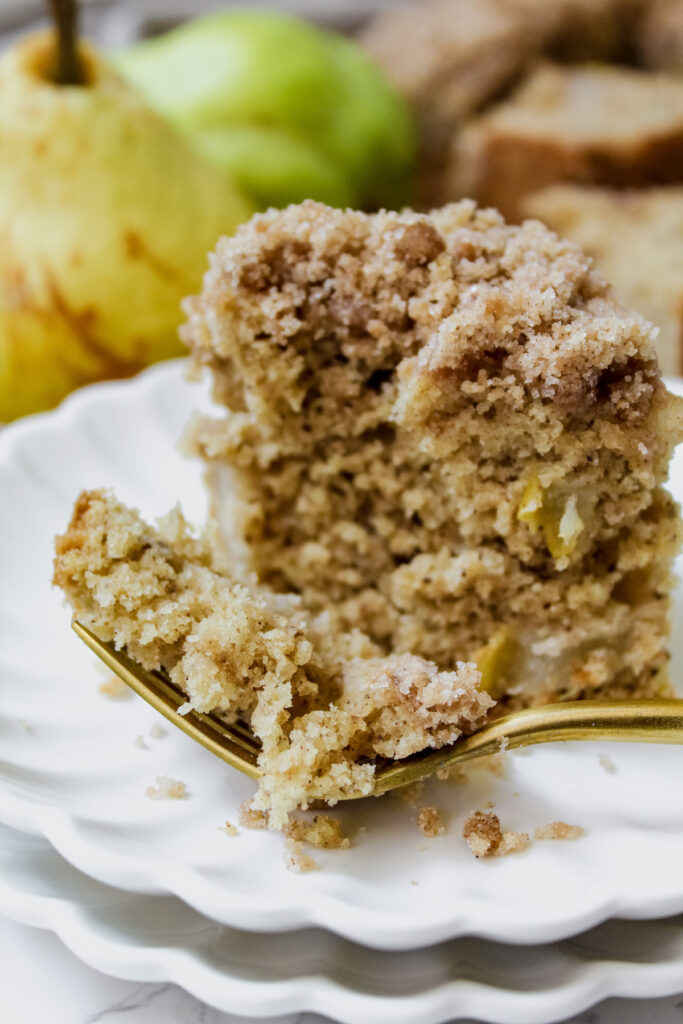 a bite of vegan pear coffee cake on a fork