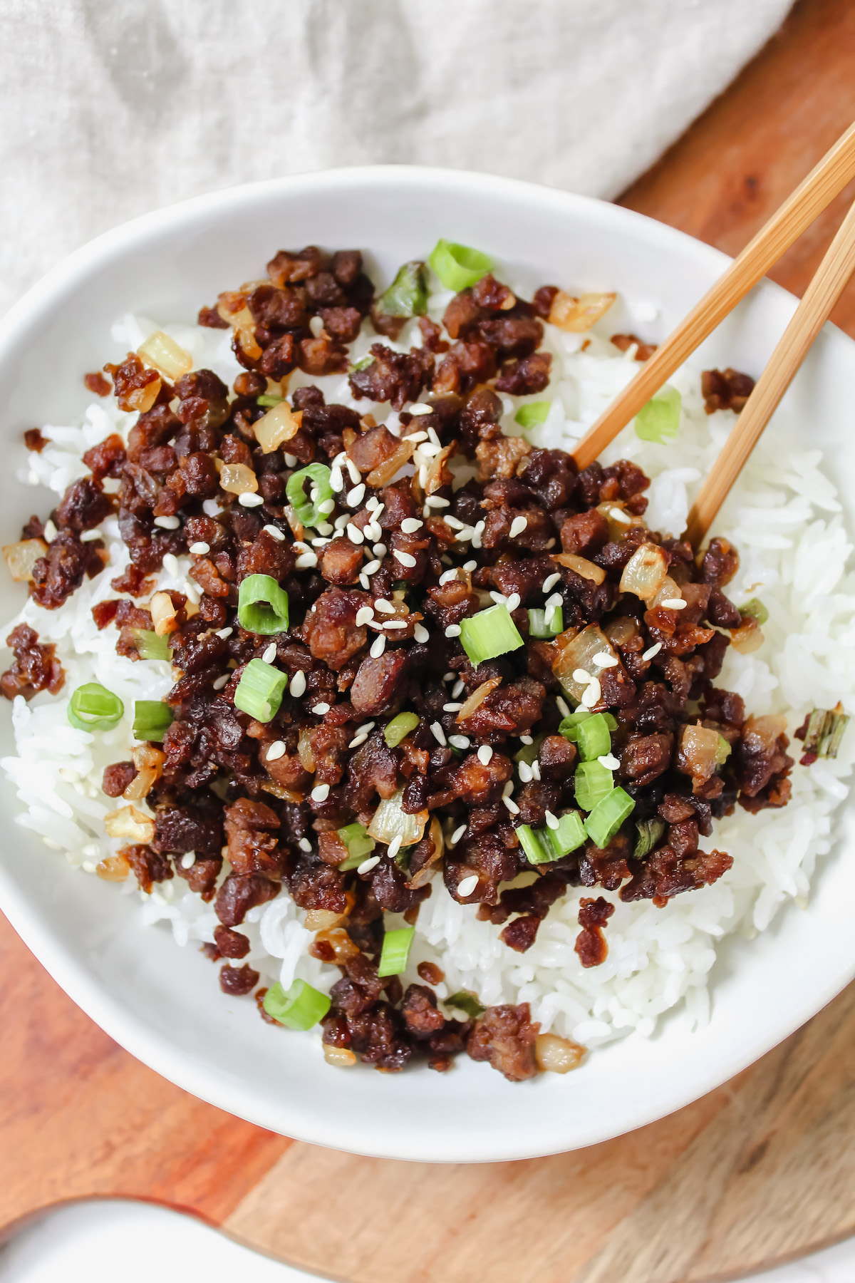 bowl of vegan beef over rice with chopsticks