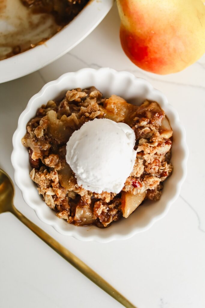 overview shot of a bowl with pear crisp and ice cream