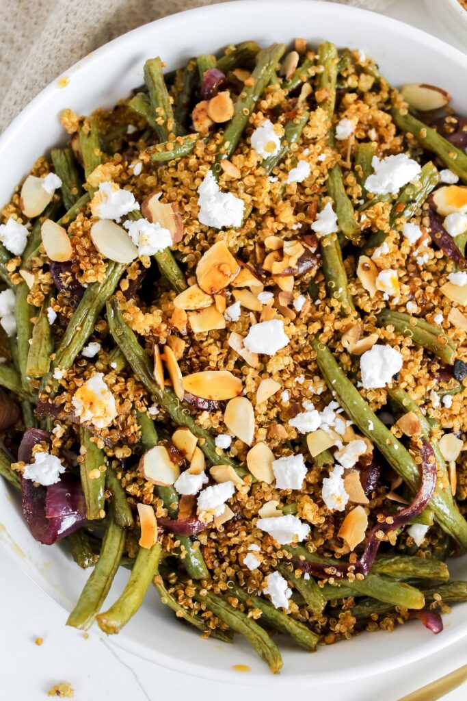 overview close up shot of roasted green beans with crispy quinoa