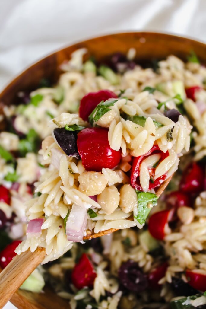 wooden spoonful of chickpea greek orzo salad
