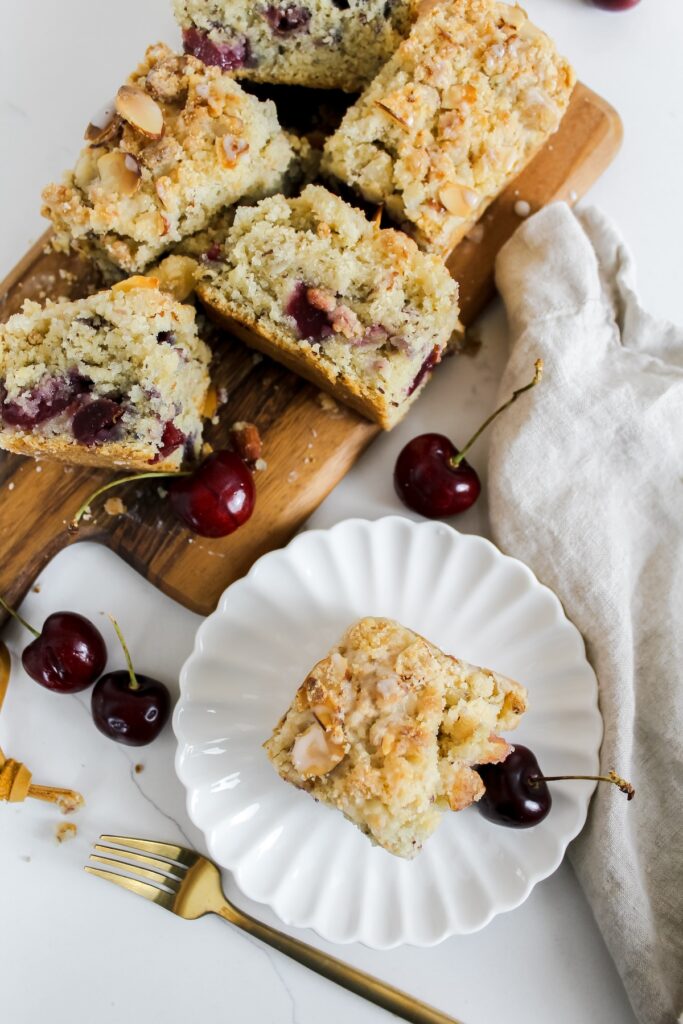 overview shot of coffee cake on a cutting board and one slice on a plate