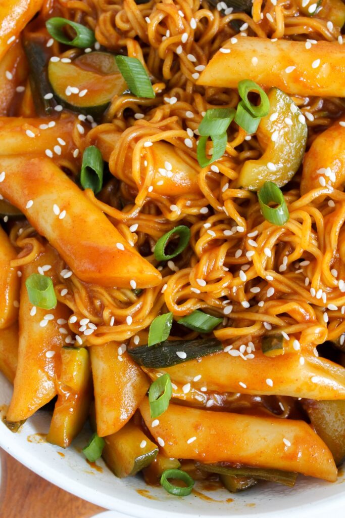 close up shot of tteokbokki and ramen