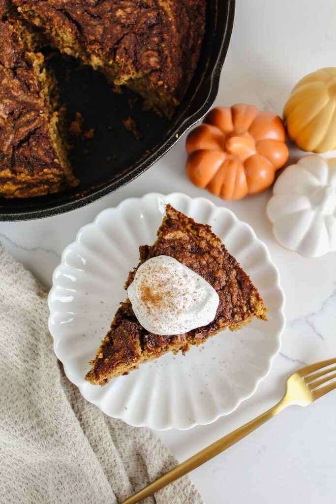 overview shot of a slice of cinnamon swirl pumpkin banana oat cake on a plate