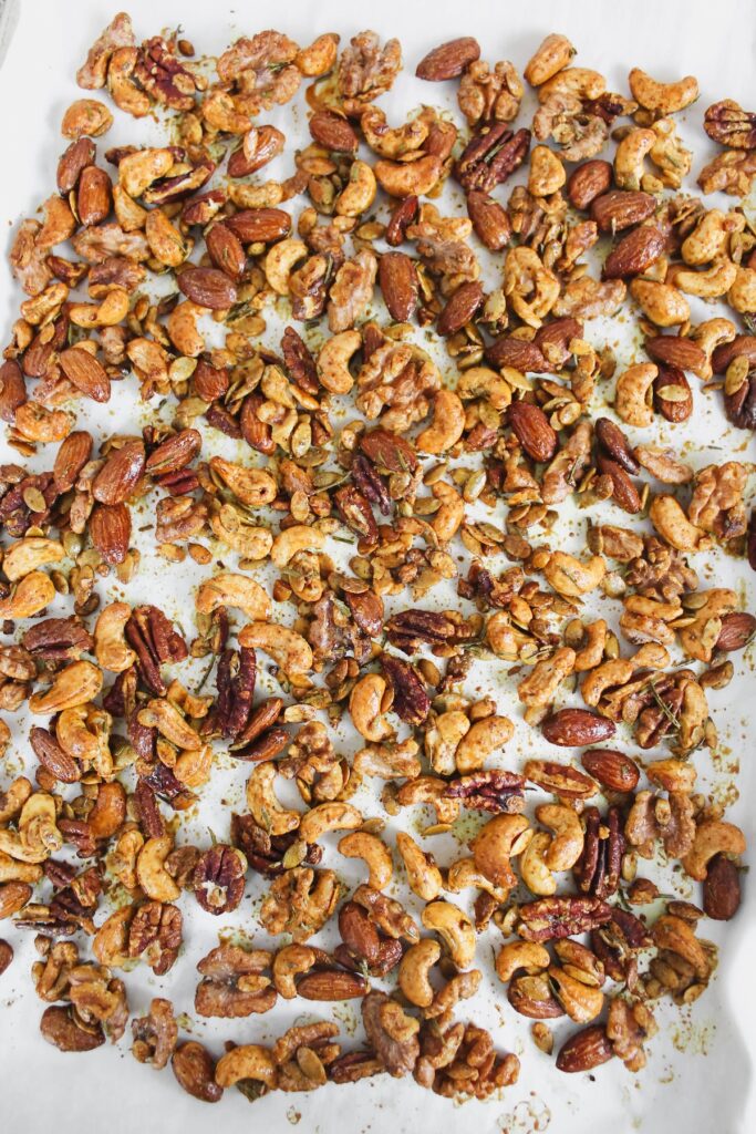 overview shot of rosemary spiced roasted nuts on a baking sheet