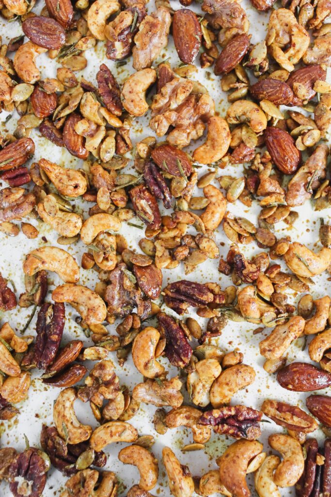 close up of roasted nuts on a baking sheet