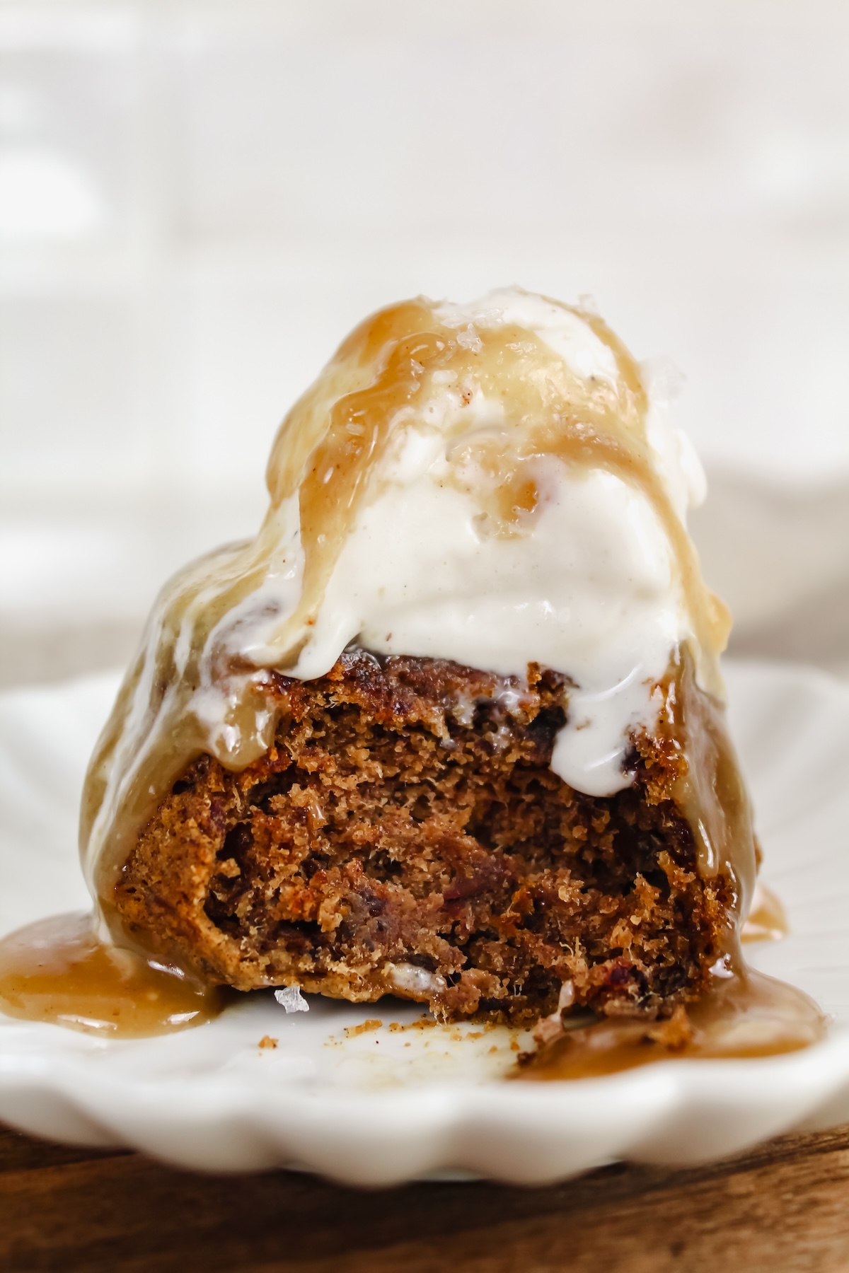 side view of healthy sticky toffee pudding with bite taken out of it