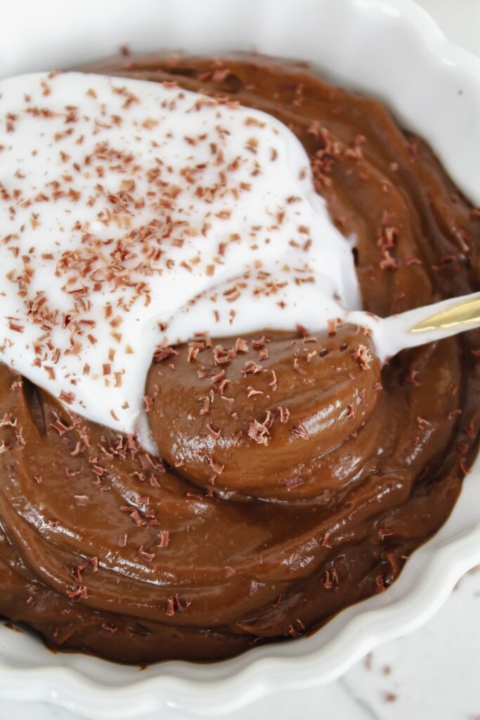 spoon in a bowl of chocolate avocado pudding