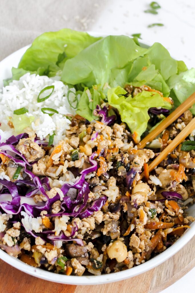 chopsticks in the bowl of tofu lettuce wraps