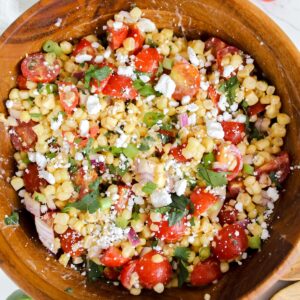 tomato corn feta salad in a wooden bowl