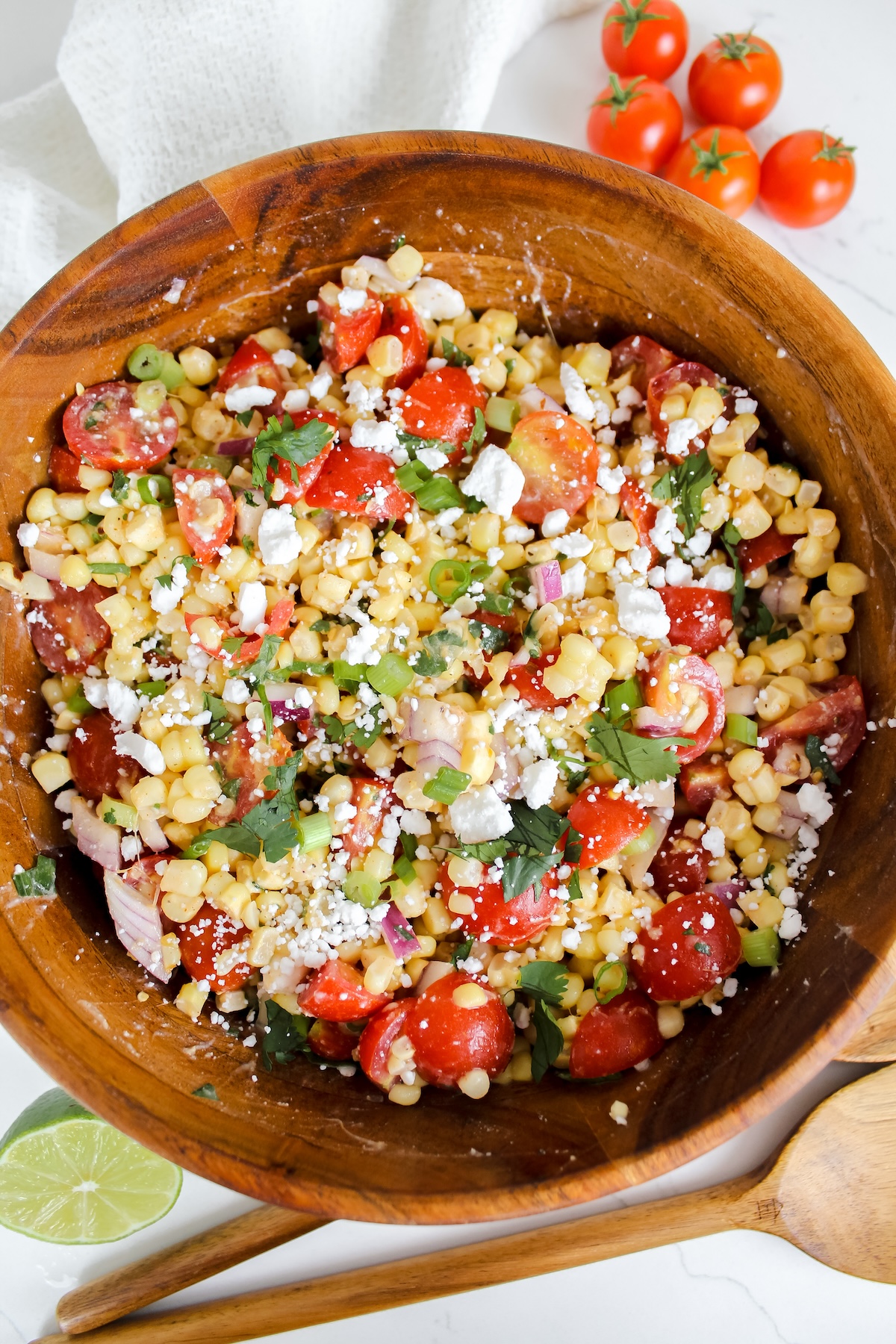 tomato corn feta salad in a wooden bowl