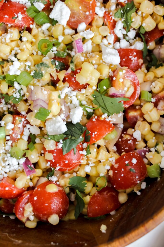 close up shot of tomato corn feta salad