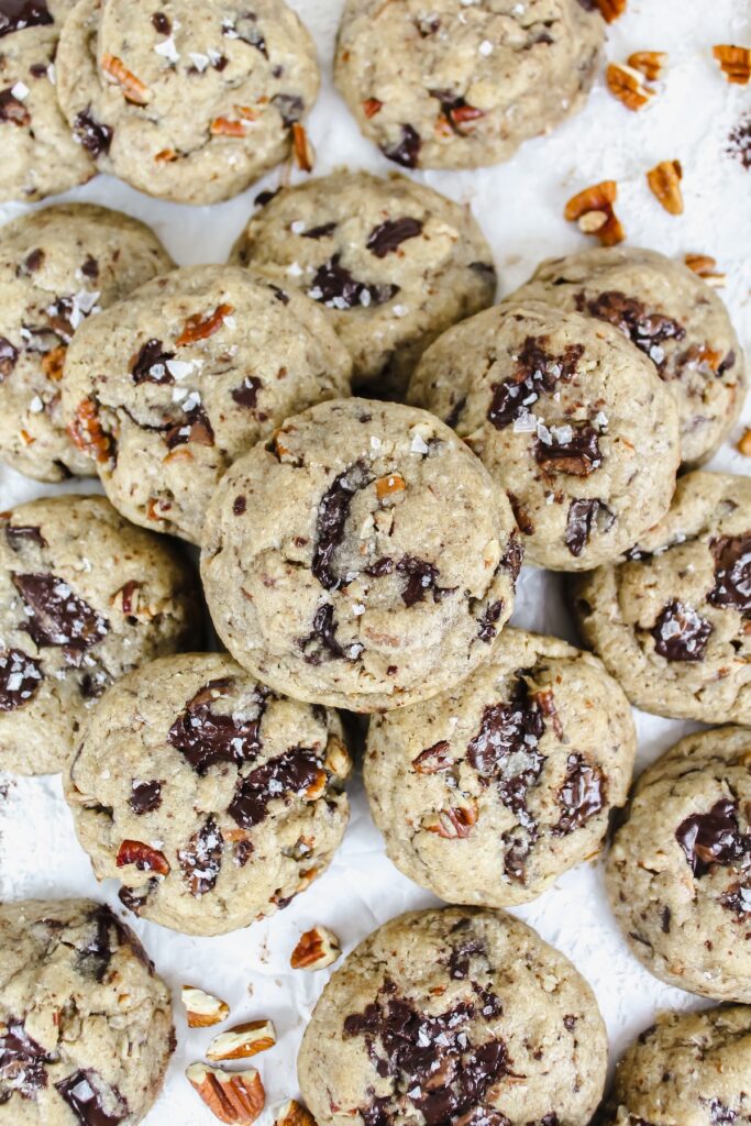 coconut pecan chocolate chip cookies piled together on a cookie sheet
