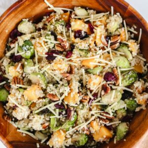 overview shot of roasted brussels sprouts and butternut squash quinoa salad in a wooden bowl