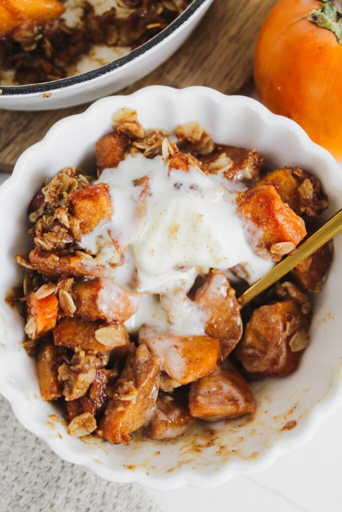 spoon in a bowl with crisp and ice cream