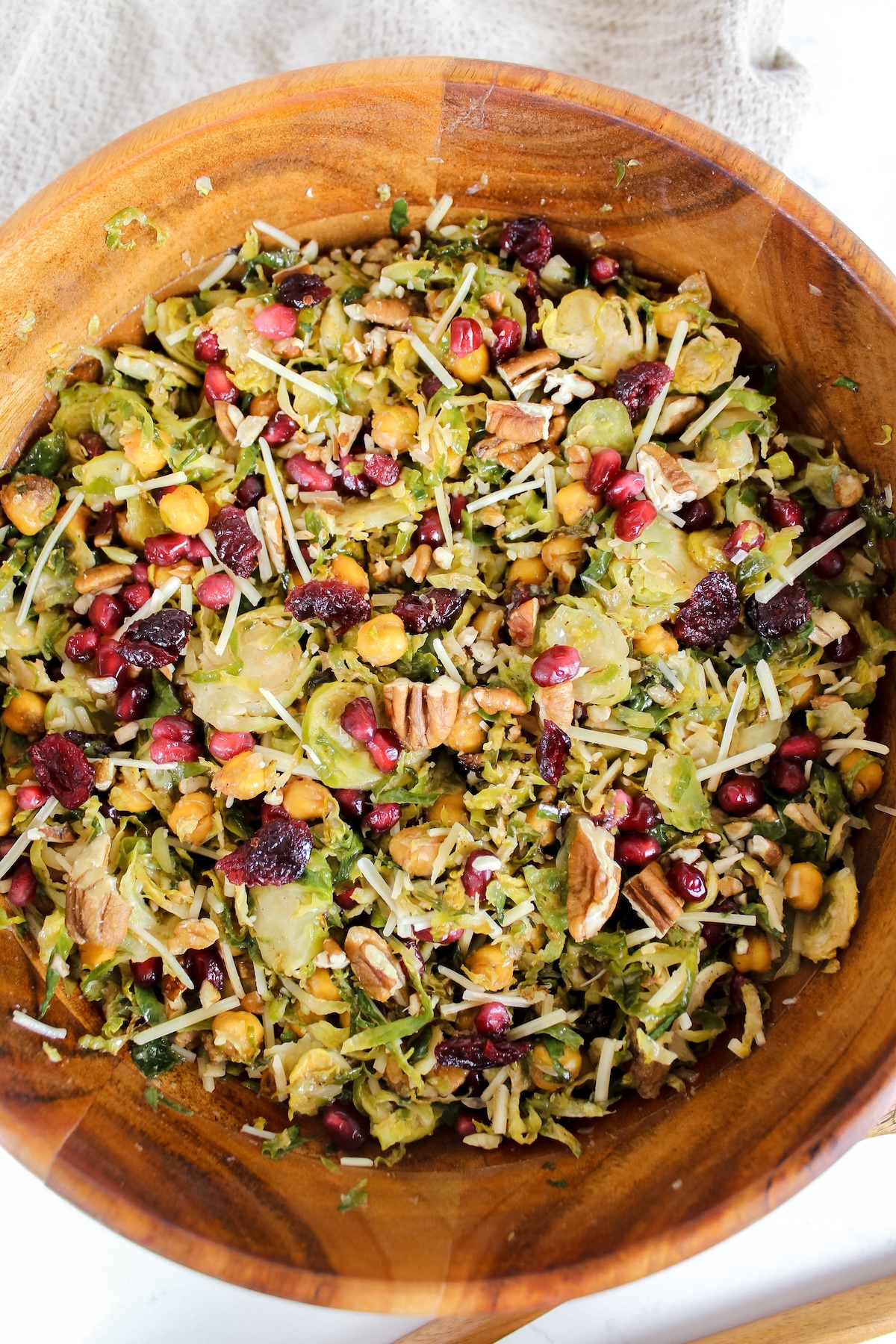 overview shot of wooden bowl with roasted shredded brussels sprouts and chickpea salad