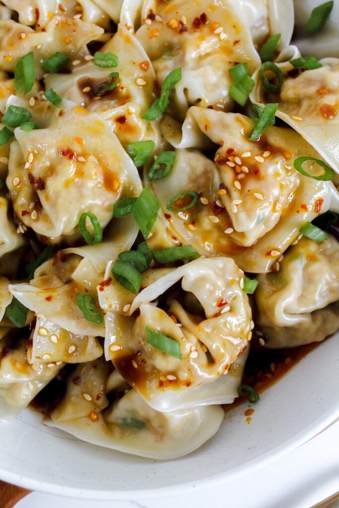 close up shot of vegan wontons in chili sauce