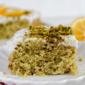 slice of lemon pistachio olive oil cake on a plate