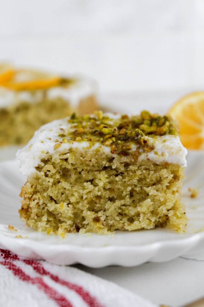 slice of lemon pistachio olive oil cake on a plate