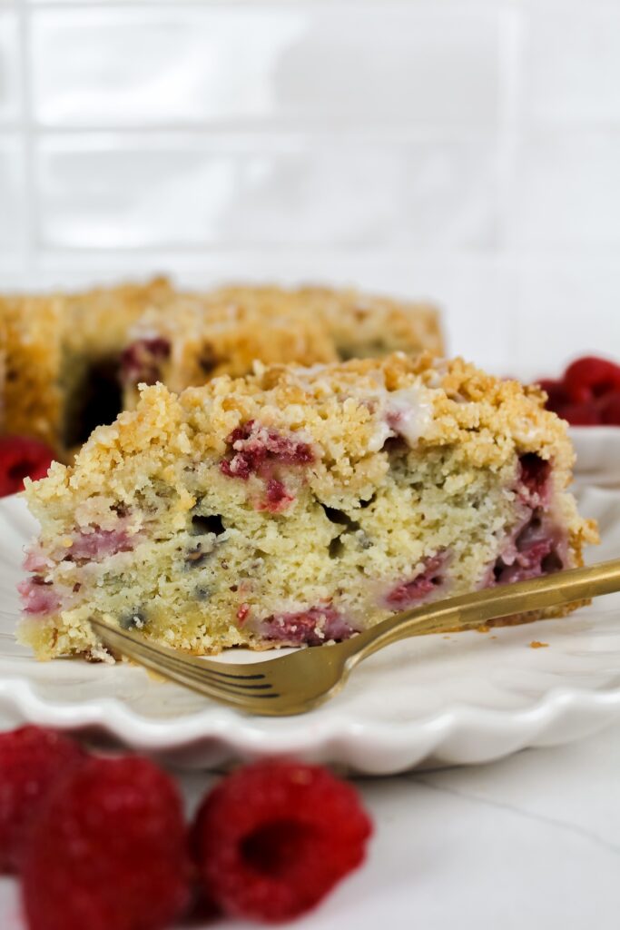slice of vegan raspberry coffee cake on a white plate