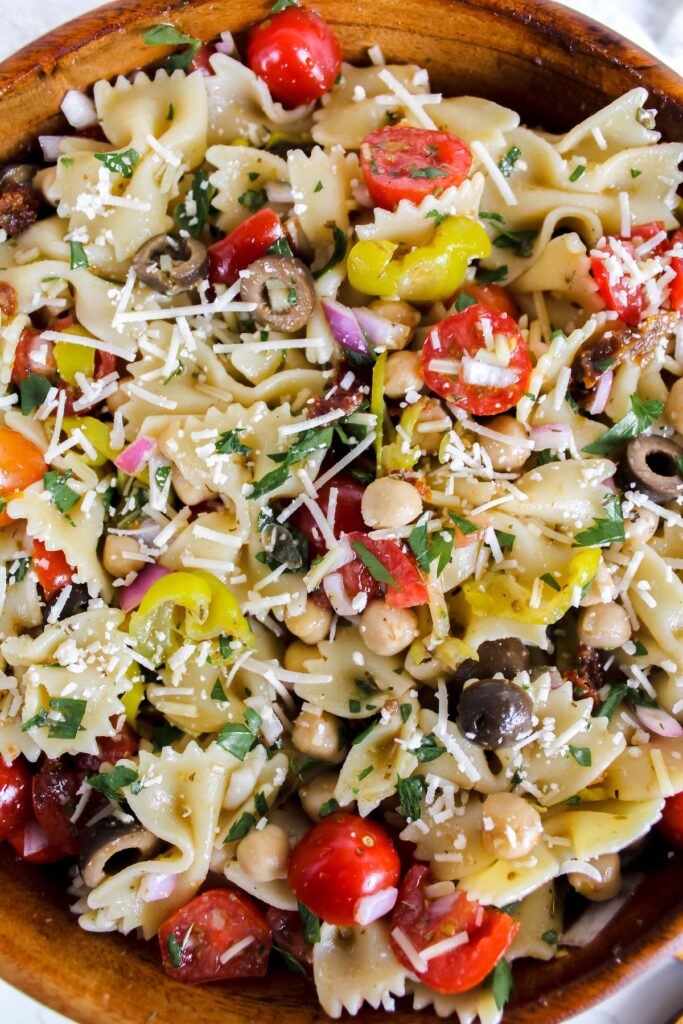 overview shot of healthy italian pasta salad in a wooden bowl
