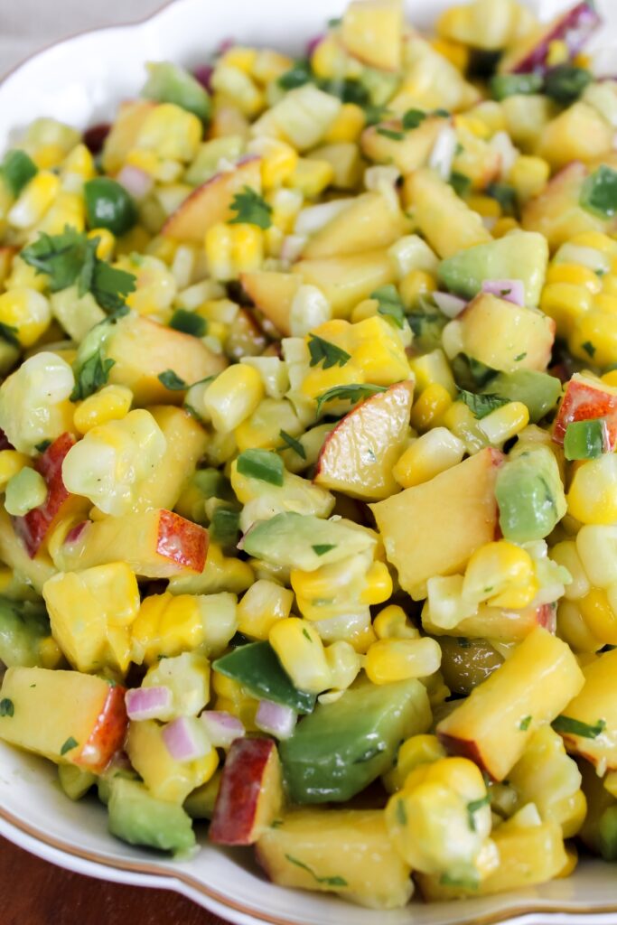 angled close up shot of corn peach avocado salsa