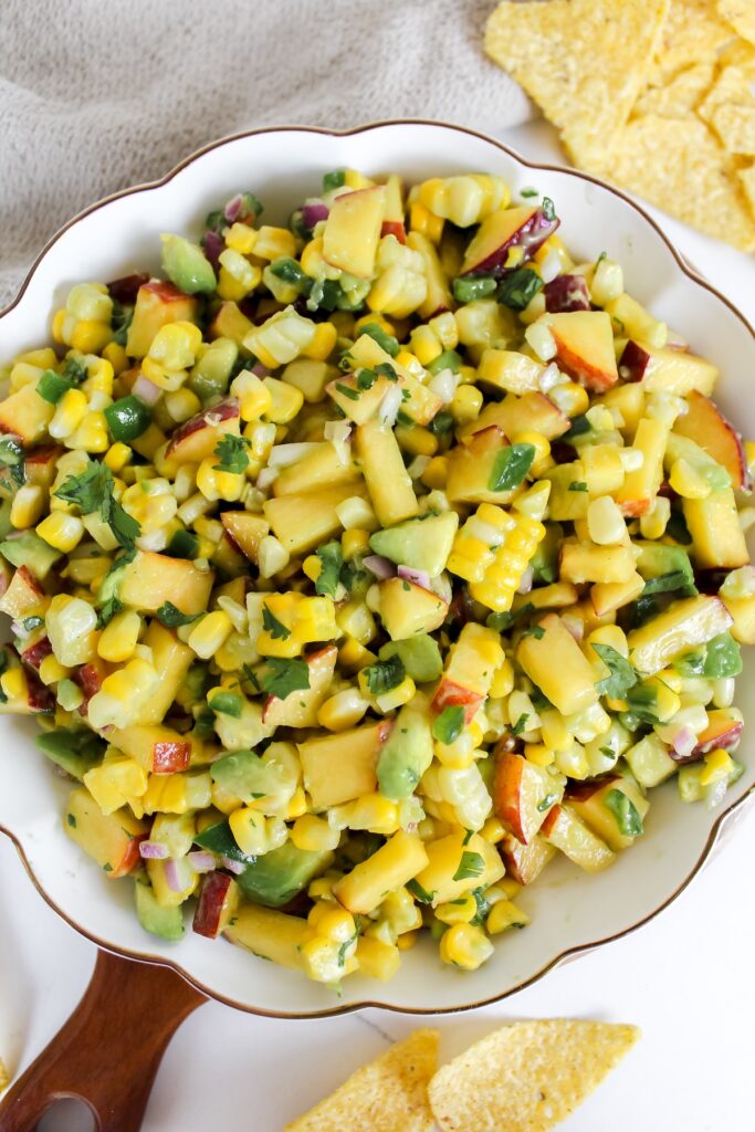 overview shot of a bowl of corn peach avocado salsa