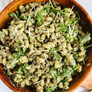overview shot of pesto pasta salad in wooden bowl