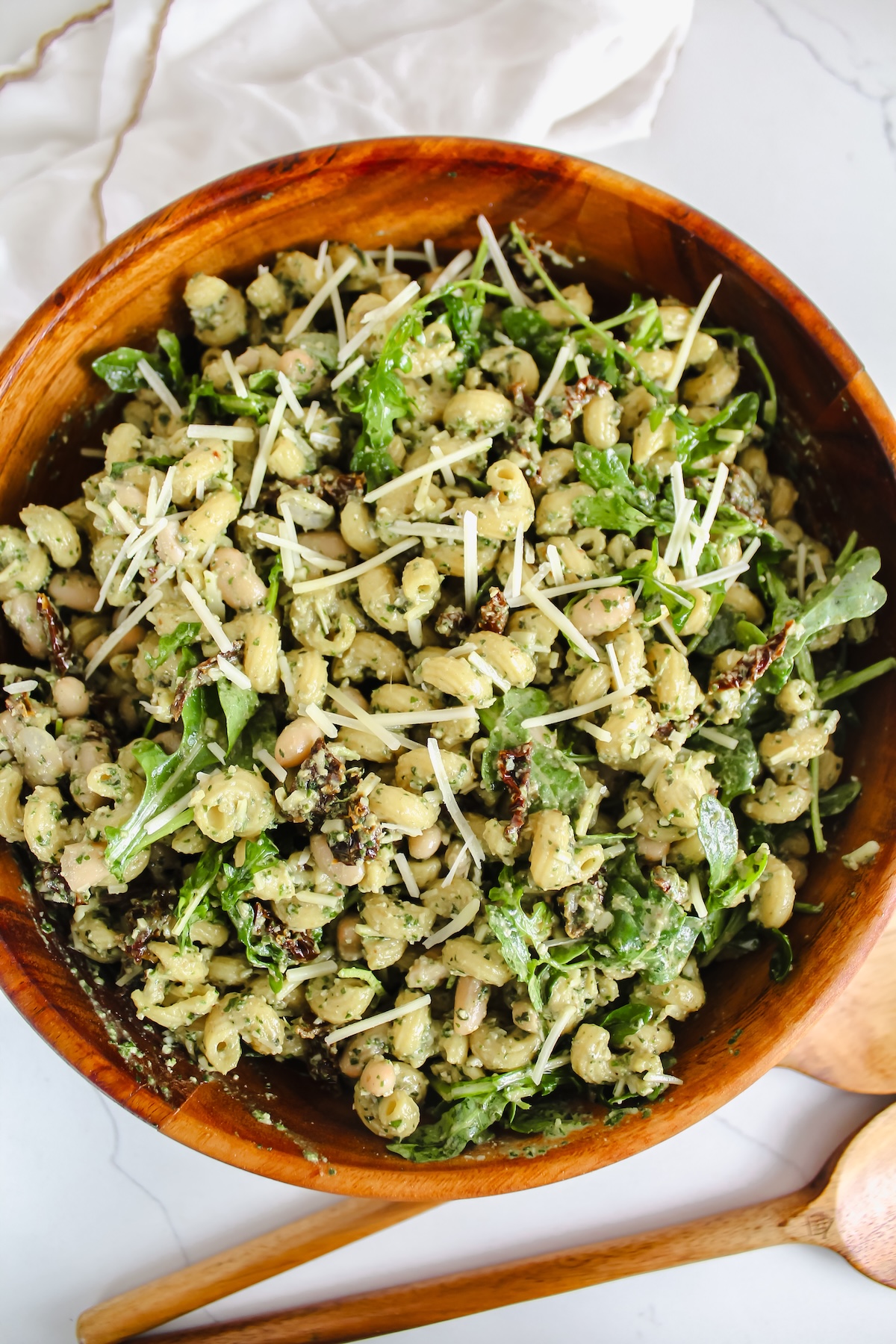 overview shot of pesto pasta salad in wooden bowl