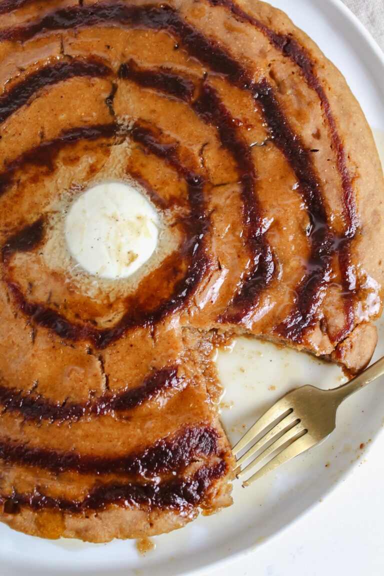 bite taken out of giant pumpkin cinnamon roll pancake