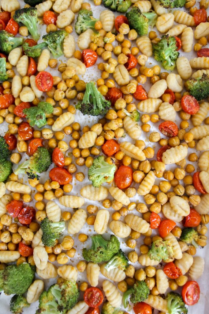 overview shot of sheet pan with gnocchi and veggies on it