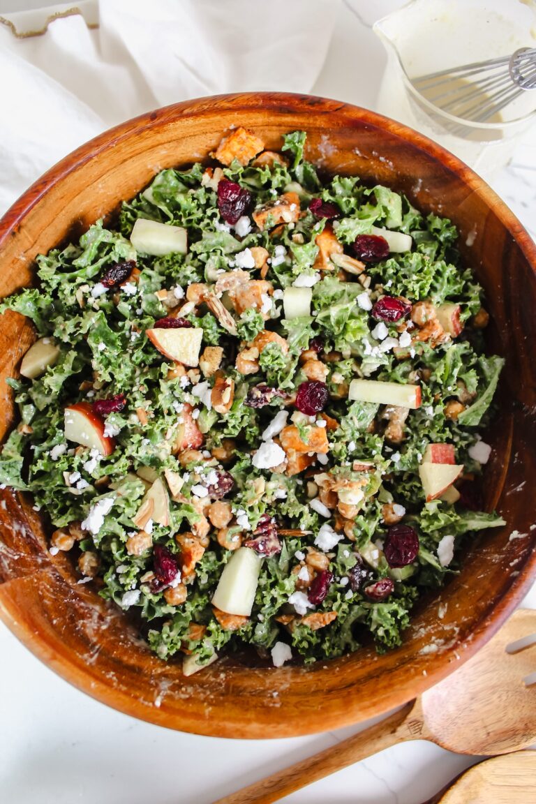 overview shot of Roasted Sweet Potato and Chickpea Kale Salad with Tangy Tahini Dressing in a wooden bowl
